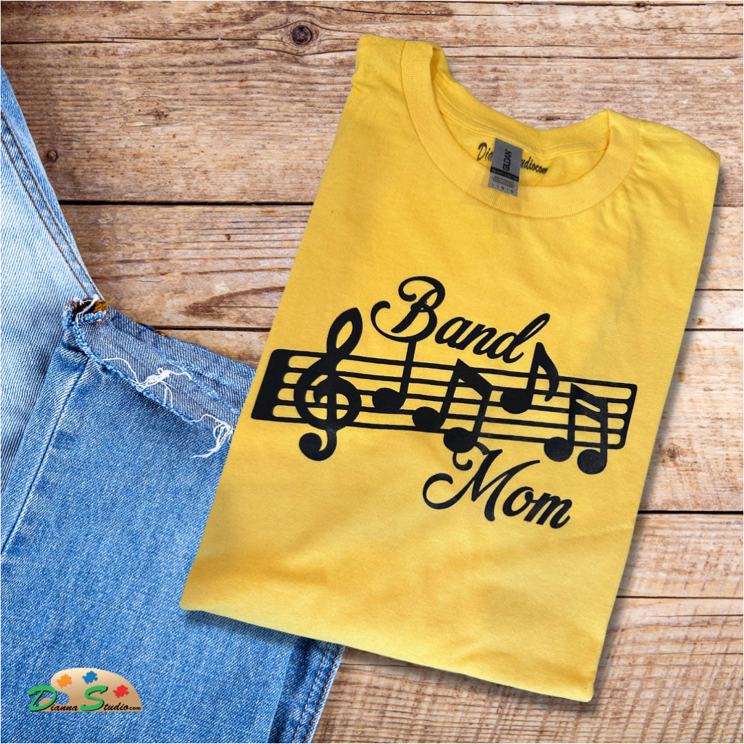 band mom design with music notes in black on gold tshirt