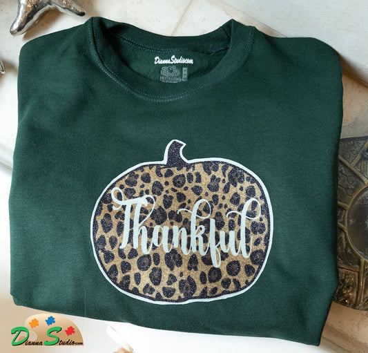 cheetah print pumpkin with Thankful, made out of glitter vinyl on a winter green sweatshirt