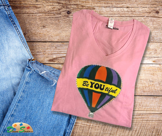 Air Balloon with Beautiful in the center on a pink v neck shirt.