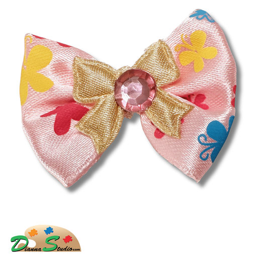 Pink with yellow, hot pink, teal butterflies. Cream bow with pink diamond in center pen bow