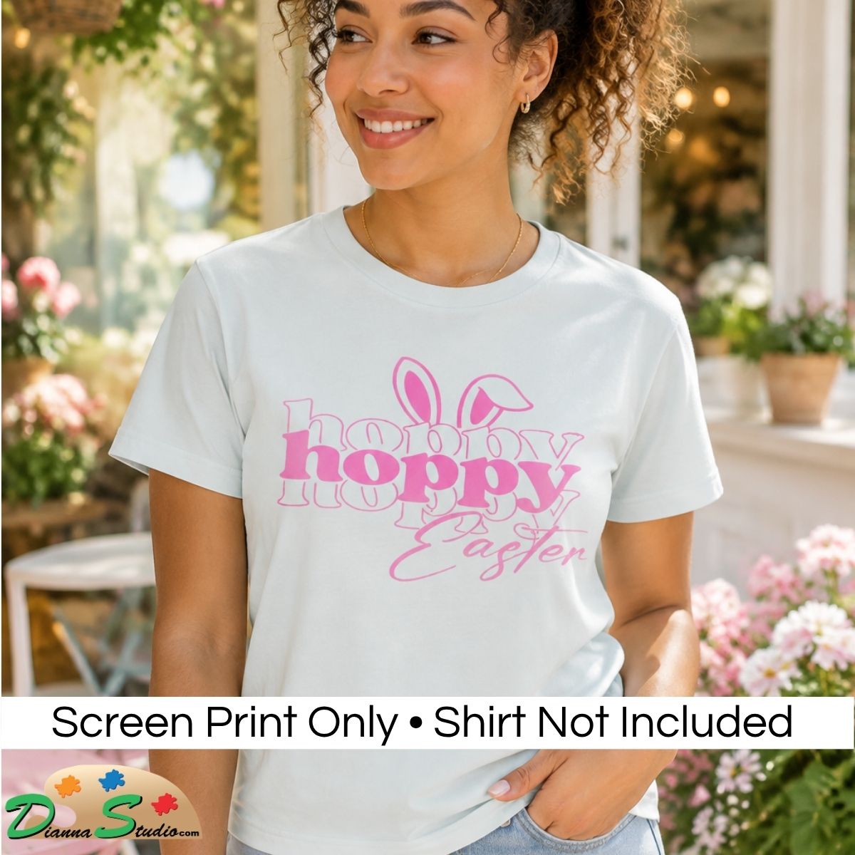 A woman wearing a white graphic T-shirt with pink bunny ears and the words 'hobby hoppy Easter' printed on the front, shown in an outdoor garden setting. A banner at the bottom reads 'Screen Print Only • Shirt Not Included' with a DiannaStudio logo.