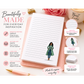 Notebook with a design of a woman in a green coat, surrounded by promotional text and images on a pink surface.