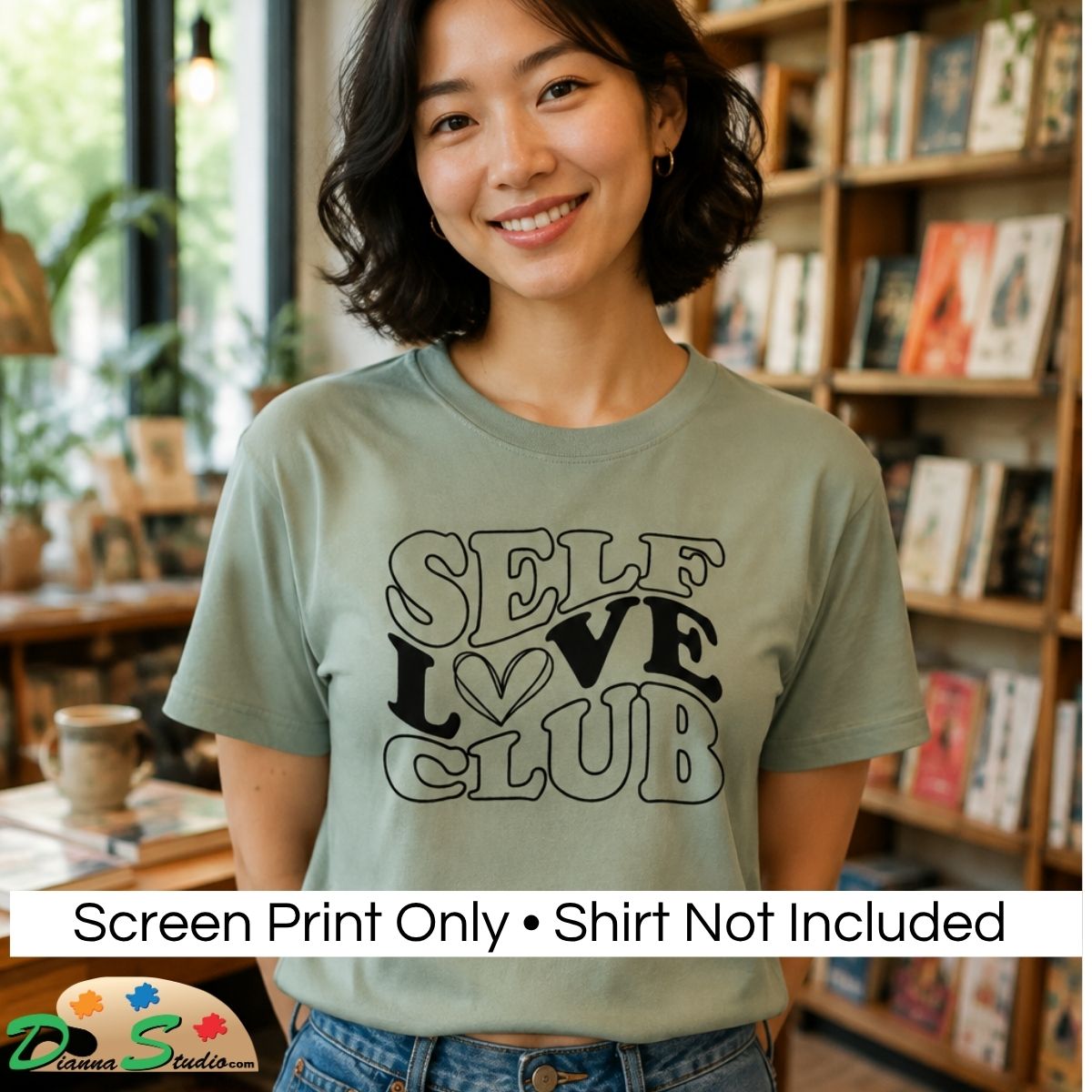 A woman wearing a sage green graphic t-shirt with the words 'SELF LOVE CLUB' printed on the front, set against a cozy bookshop background. A white banner at the bottom reads 'Screen Print Only • Shirt Not Included'.