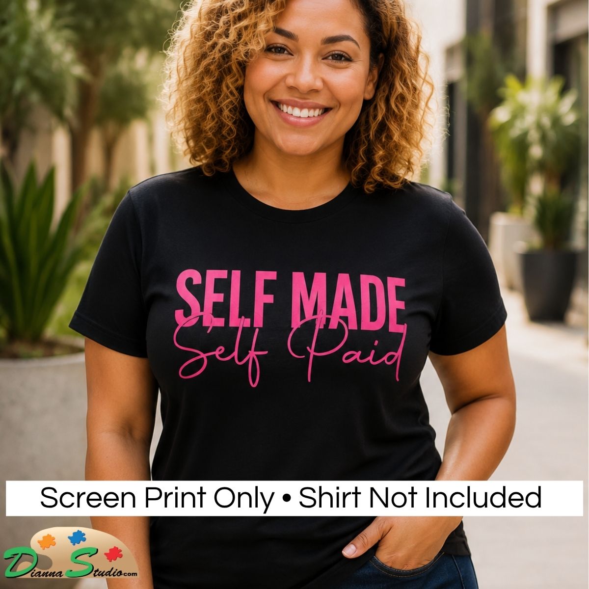 A smiling woman with curly hair wears a black graphic T-shirt with the words 'SELF MADE Self Paid' in hot pink lettering. The photo is taken outdoors with blurred plants and buildings in the background, and a white banner at the bottom reads 'Screen Print Only • Shirt Not Included' with a 'DiannaStudio' logo.