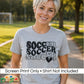 A woman outdoors wearing a heather gray t-shirt with a black and white graphic that reads 'SOCCER SOCCER SOCCER' with a heart. A white banner at the bottom says 'Screen Print Only • Shirt Not Included' and shows the 'DiannaStudios' logo.