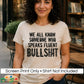 A woman wearing a cream-colored graphic t-shirt with bold black text that reads 'WE ALL KNOW SOMEONE WHO SPEAKS FLUENT BULLSHIT'. A white banner at the bottom states 'Screen Print Only • Shirt Not Included' with the 'DiannaStudio' logo in the corner, set against a blurred background of a bookstore.
