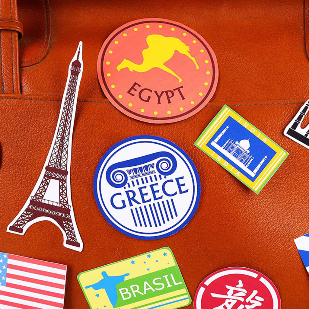 Colorful travel-themed stickers displayed on a brown leather suitcase.