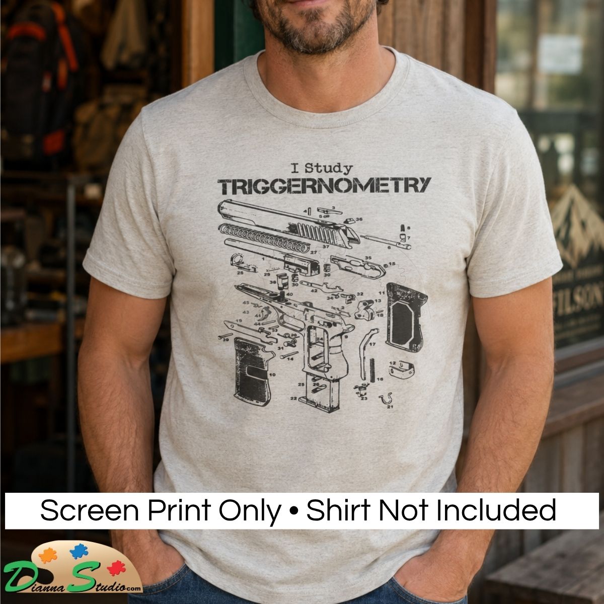 A man wearing a light heather gray t-shirt with a black exploded-view graphic of a firearm and the text 'I Study TRIGGERIONOMETRY'. A white banner at the bottom reads 'Screen Print Only • Shirt Not Included'.