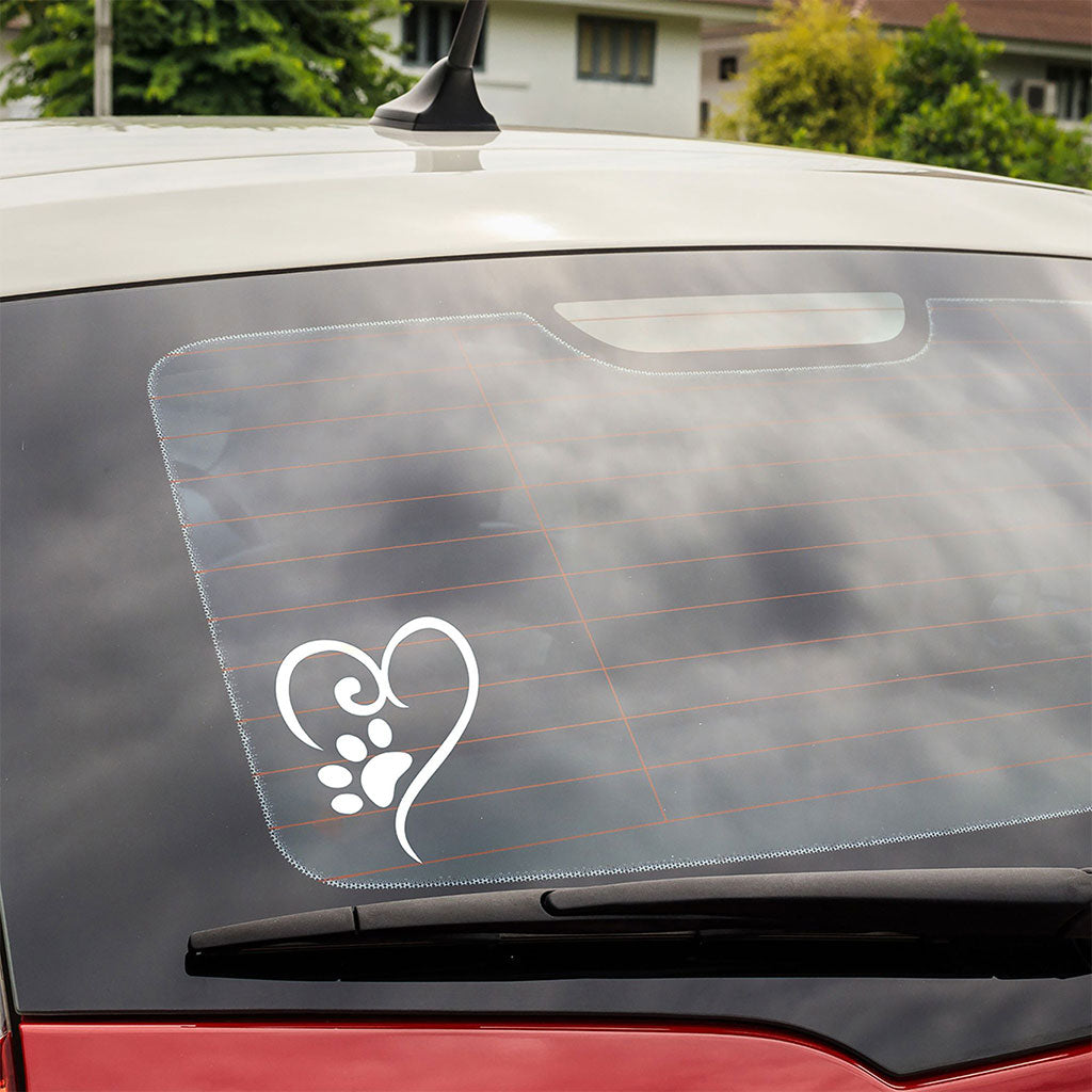 White heart and paw print vinyl decal applied to a vehicle rear window.